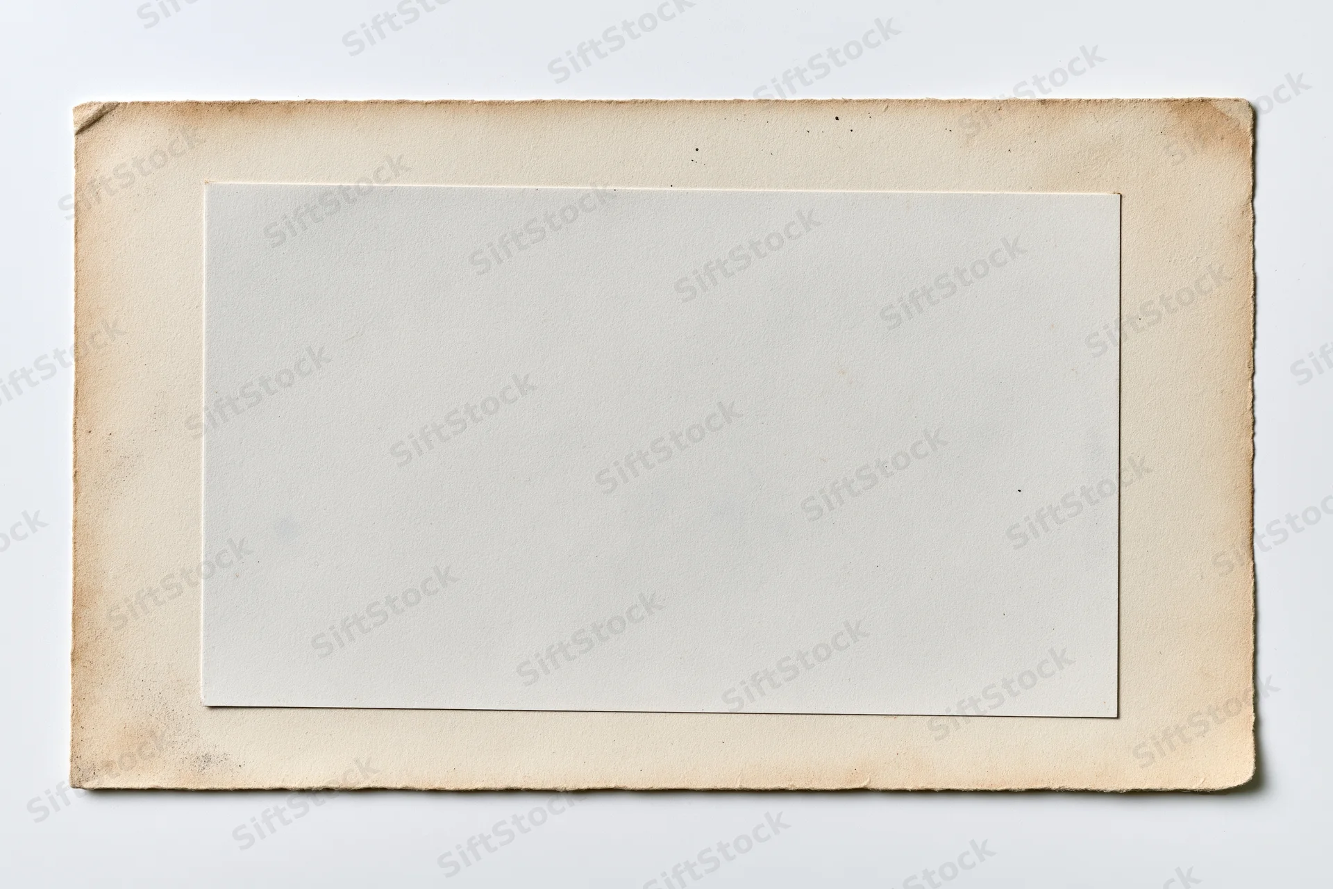 Vintage photo print with blank white center and aged beige border lying flat