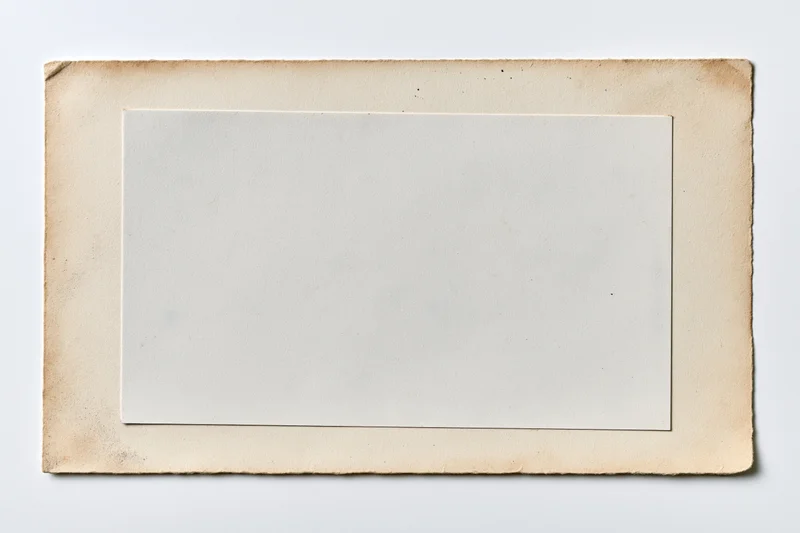 Vintage photo print with blank white center and aged beige border lying flat
