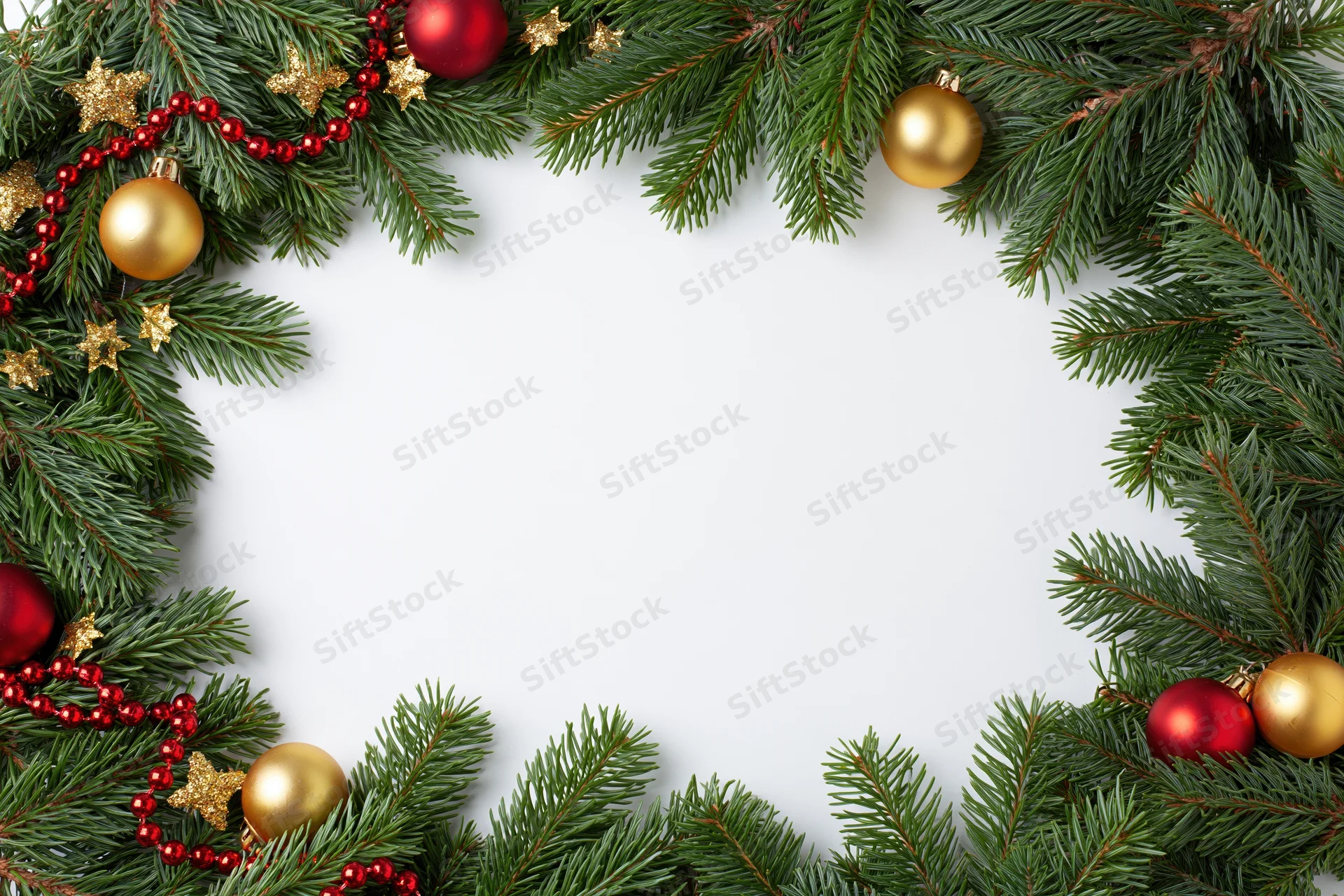 Fir branches with red and gold ornaments arranged as a festive border frame on white background