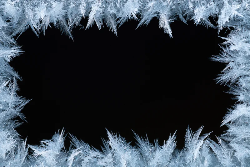 Frost crystals forming a natural border around a black center