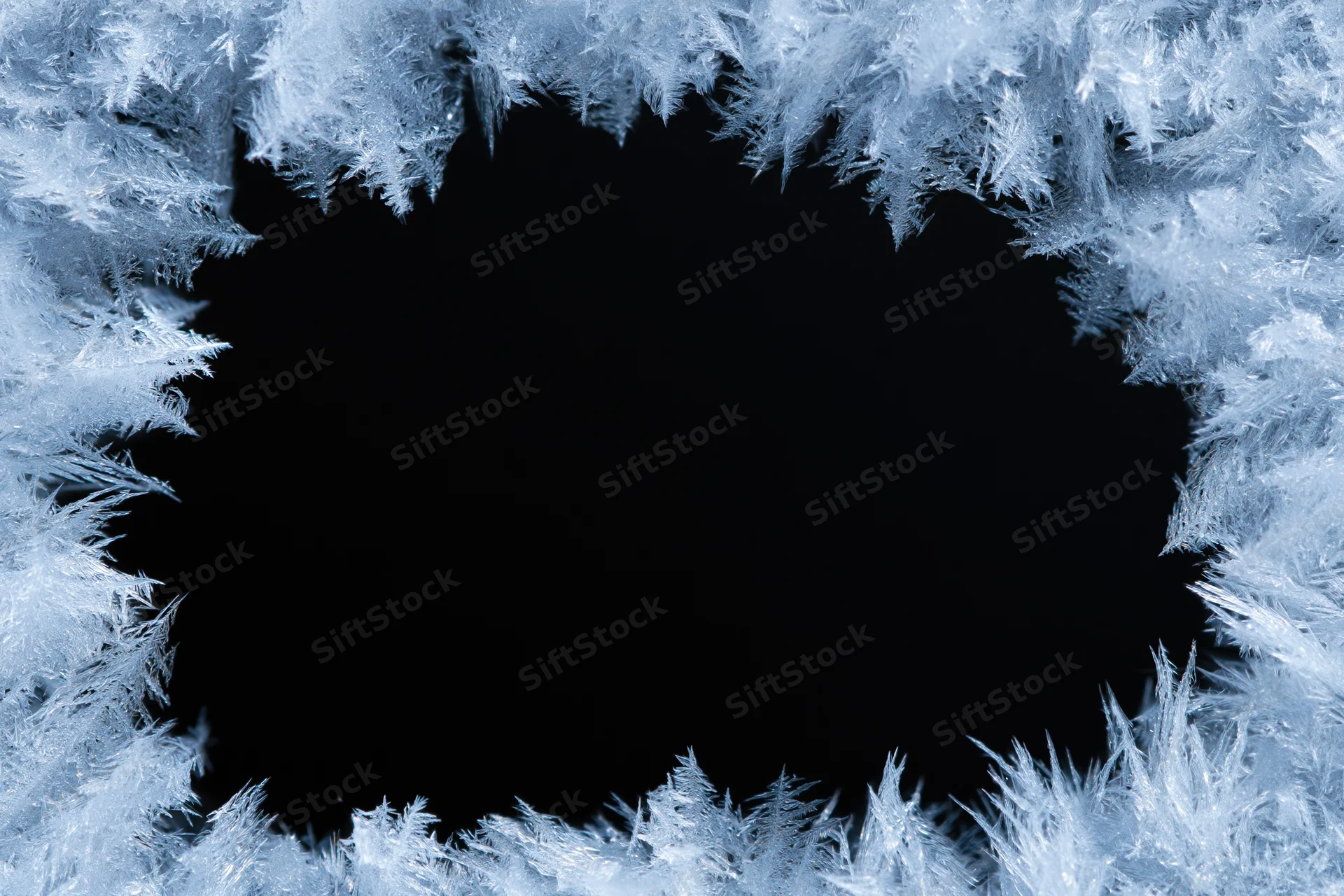 Frost crystals forming a natural border around a dark center