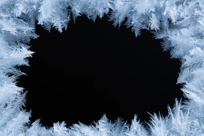 Frost crystals forming a natural border around a dark center