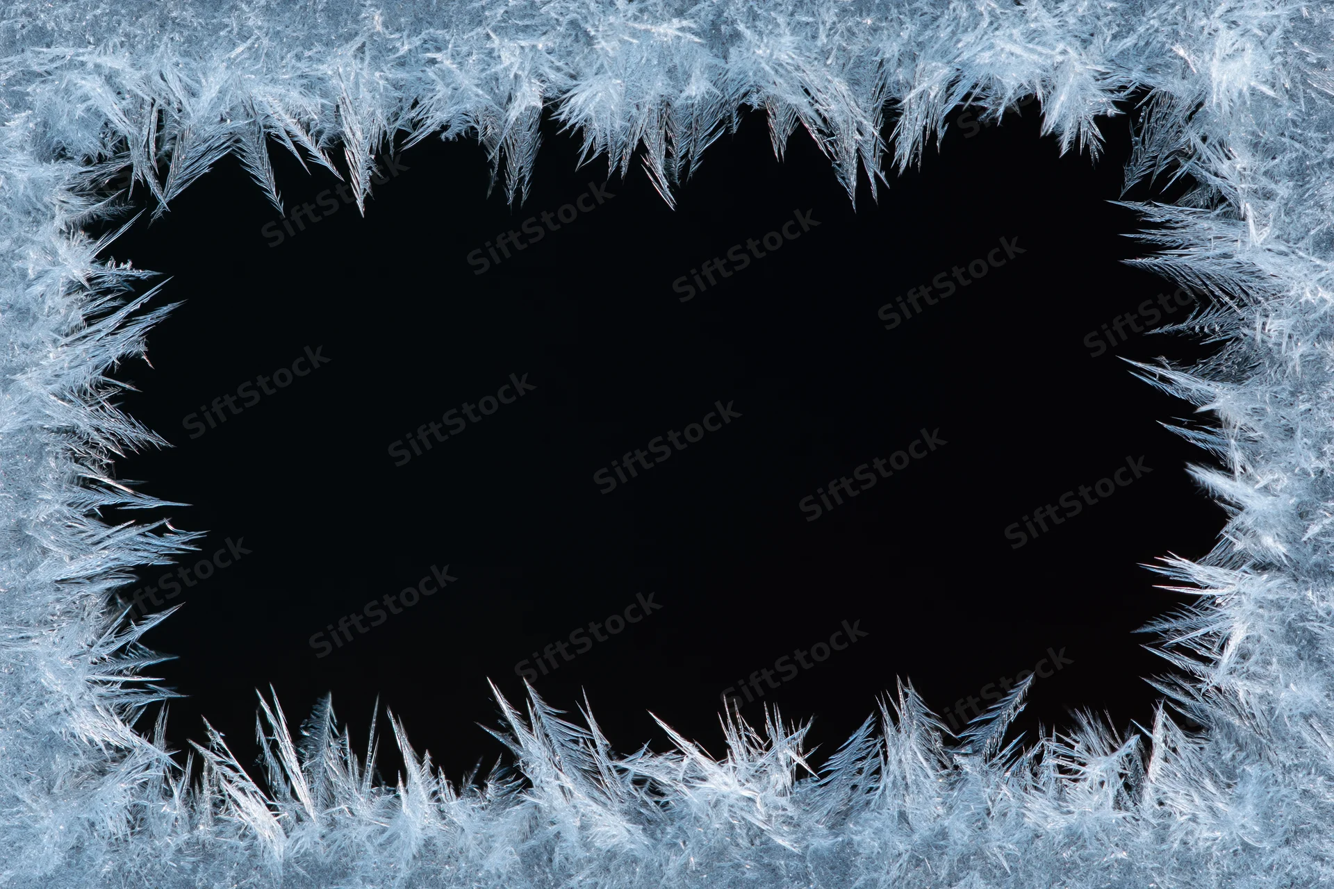 Frost crystals forming a natural border around a dark center