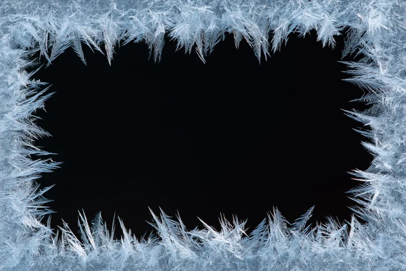 Frost crystals forming a natural border around a dark center