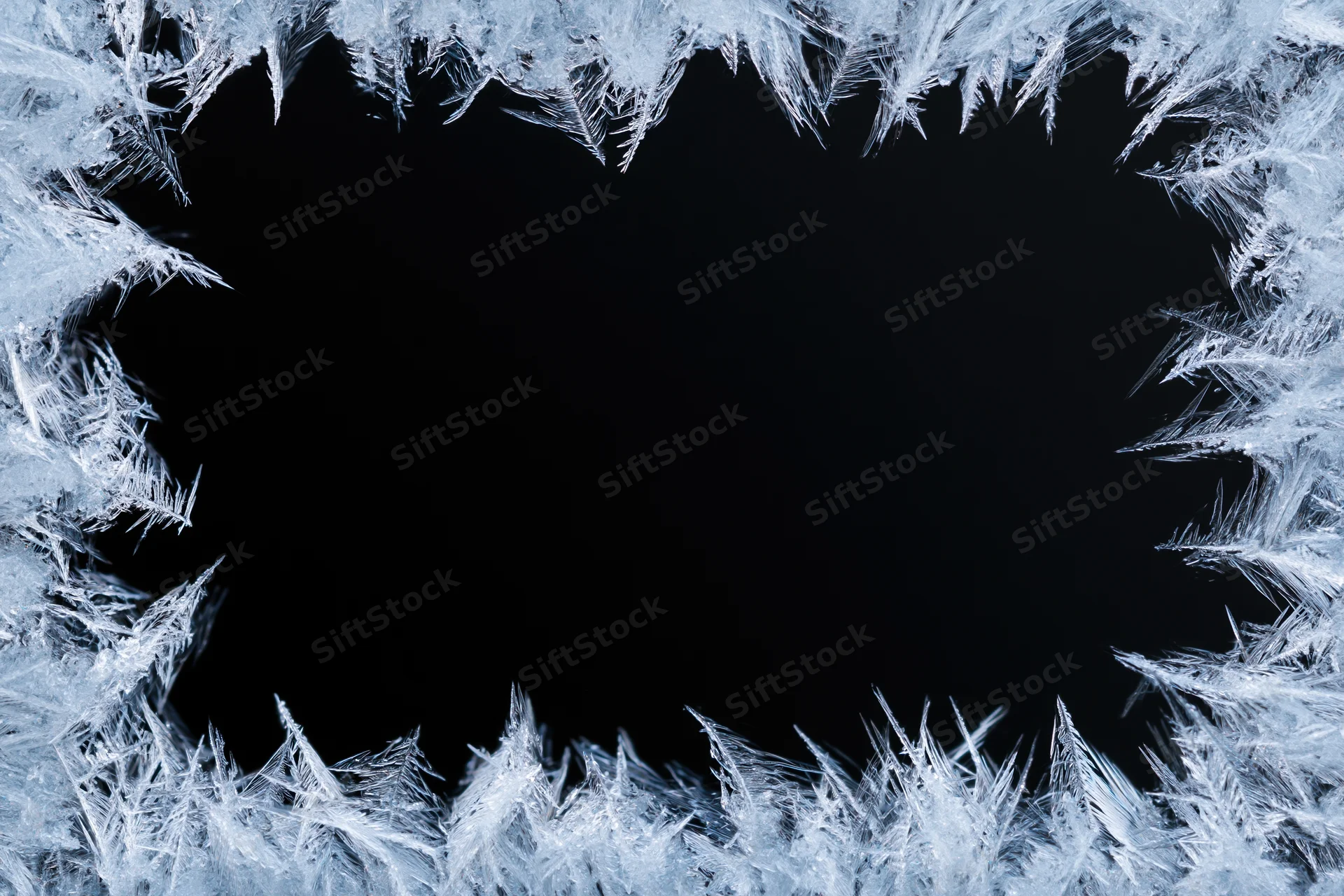Frost crystals forming a natural border around a dark center