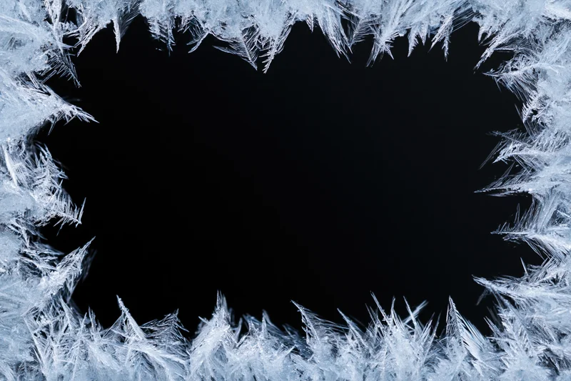 Frost crystals forming a natural border around a dark center