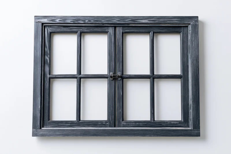 Double-hung wooden window frame with multiple panes isolated on white background