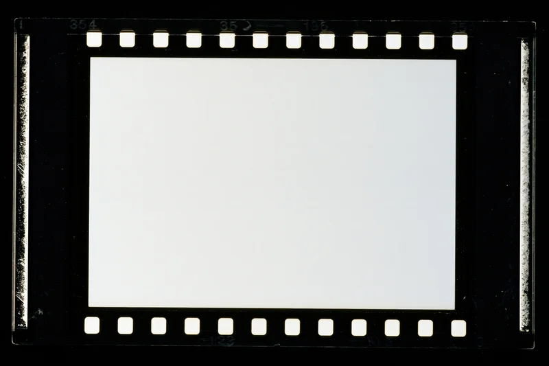 Blank 35mm film negative frame with sprocket holes on black background