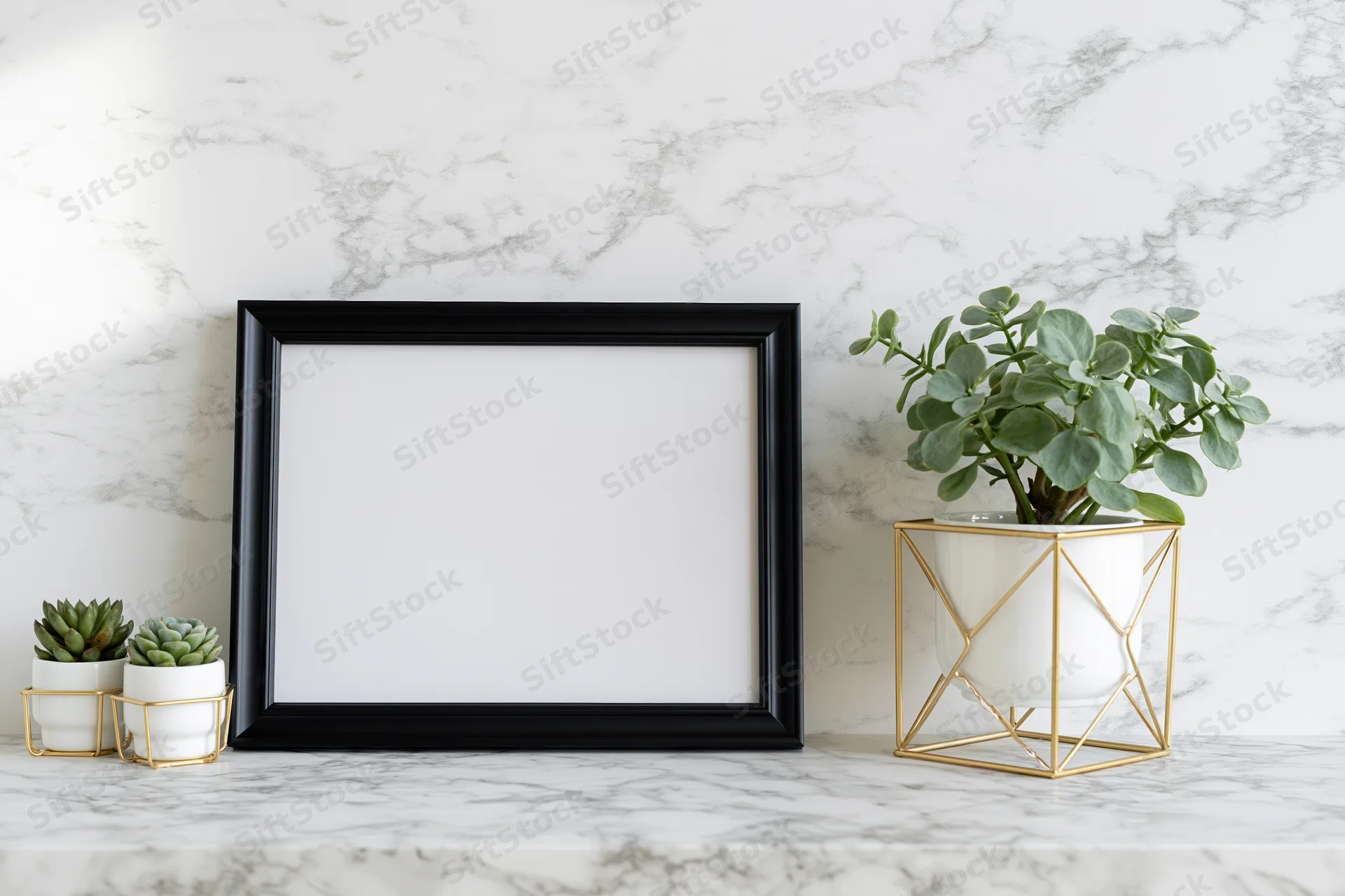 Empty black picture frame leaning against white marble wall with potted plants on countertop