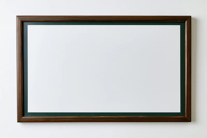 Empty dark green chalkboard with white surface mounted on a wall