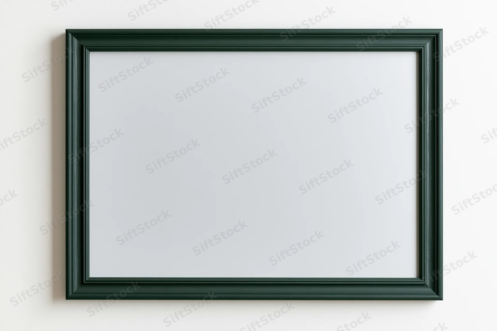 Dark green frame with blank white surface hanging on a wall