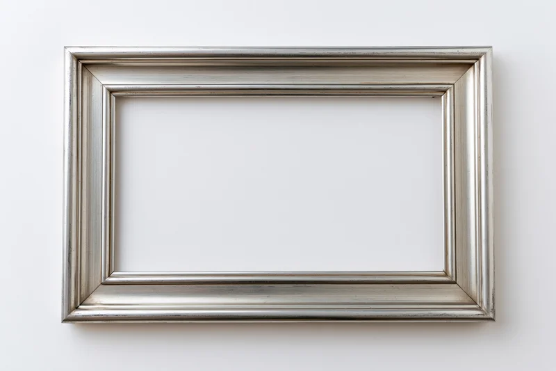 Silver empty picture frame with molded edges hanging on white wall
