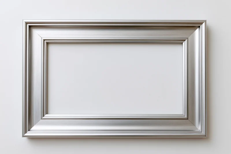 Silver picture frame hanging on white wall with empty center for display