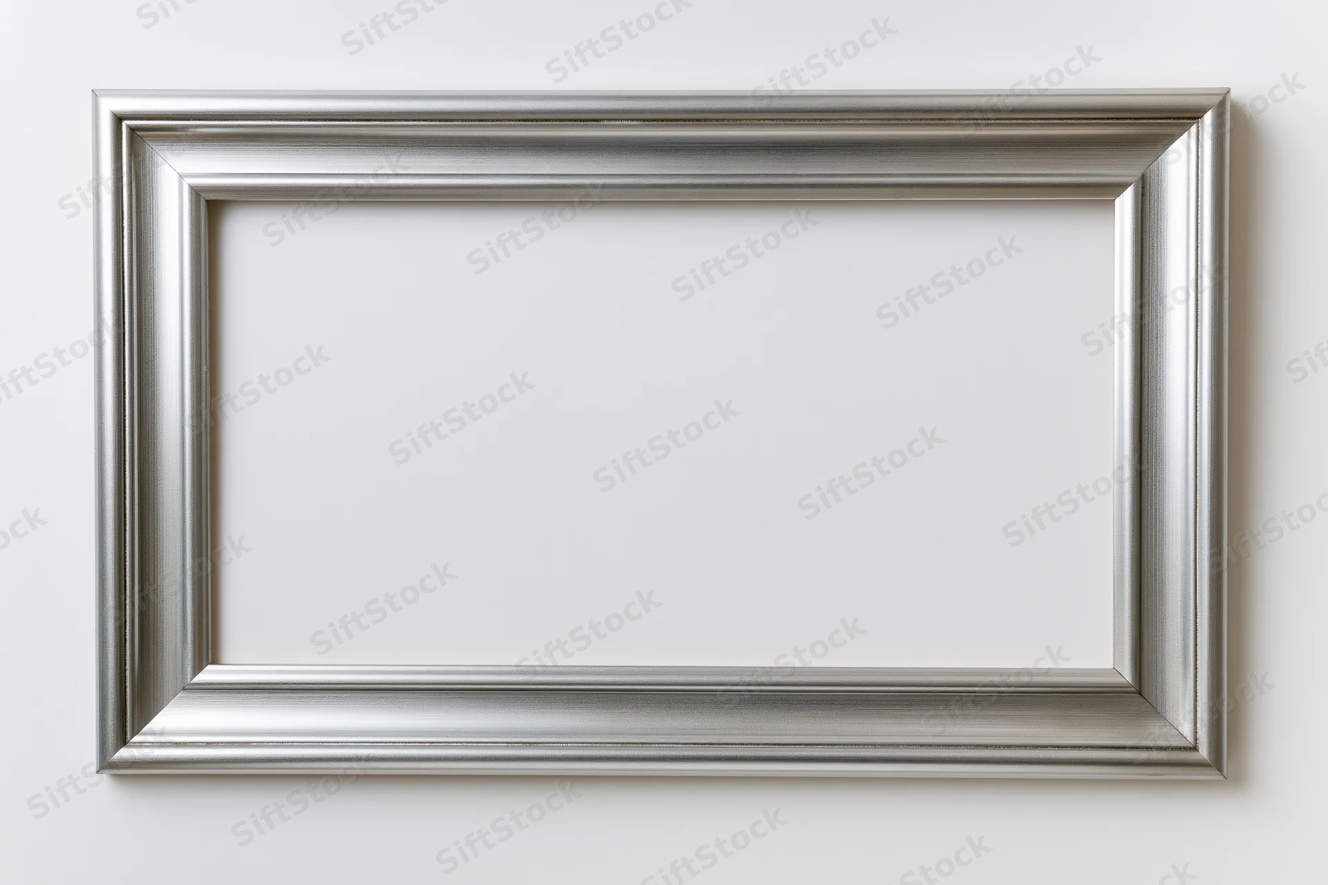 Silver picture frame with molded edges hanging on white wall