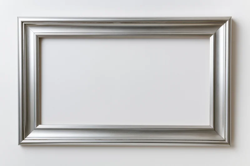 Silver picture frame with molded edges hanging on white wall