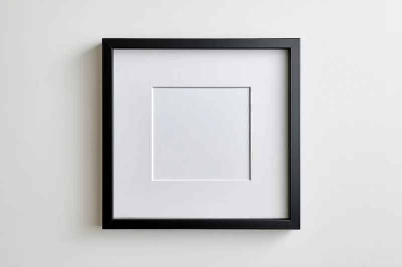Black square frame with white mat centered on a plain wall