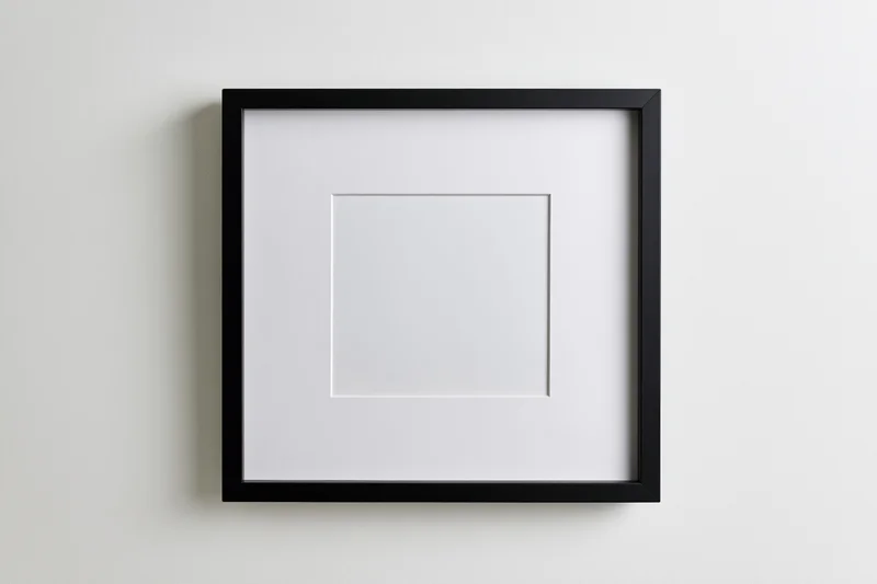 Black square frame with white mat centered on a plain wall