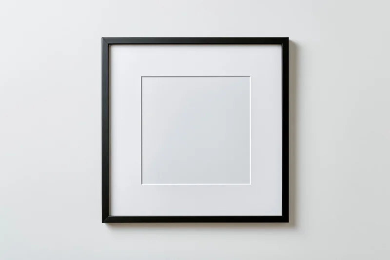 Empty square black picture frame with white mat centered on a plain white wall