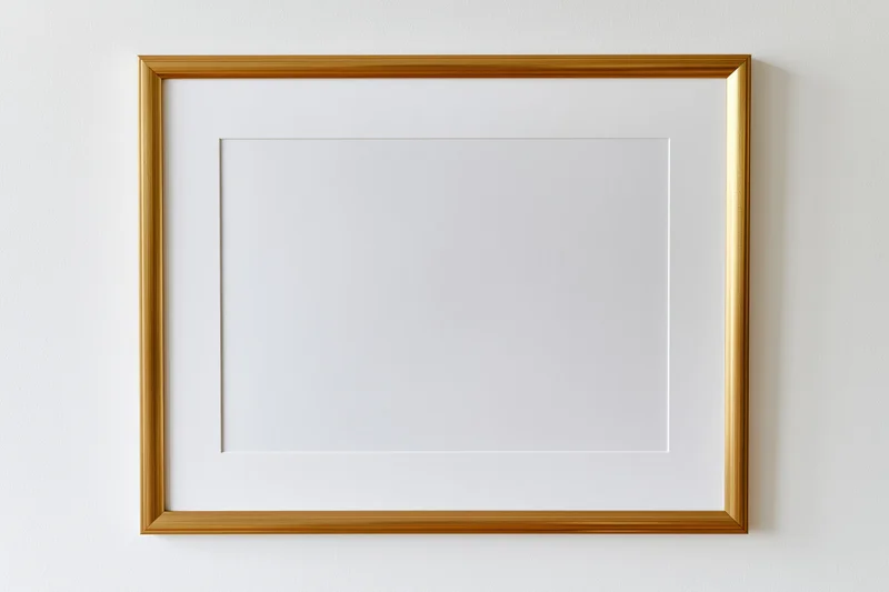 Gold picture frame with blank white mat mounted on white wall