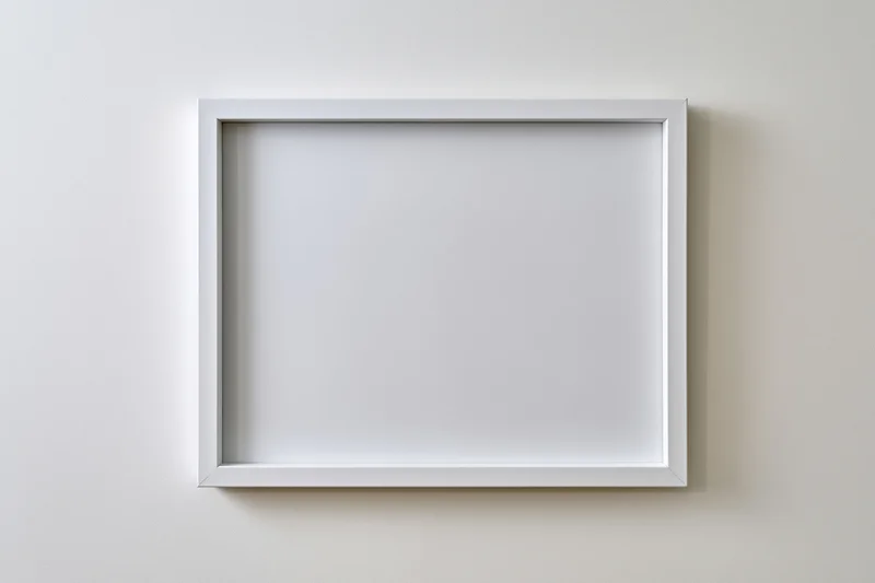 White empty picture frame mounted on off-white wall