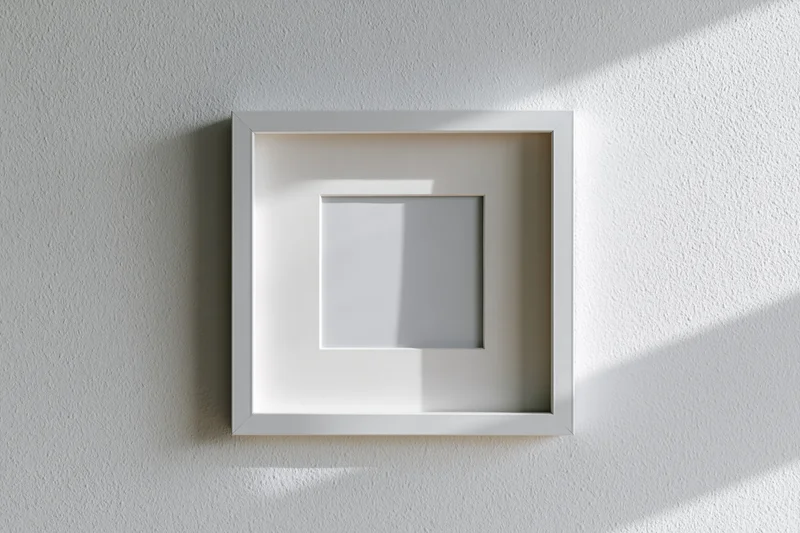 White square picture frame with wide mat hanging on textured wall