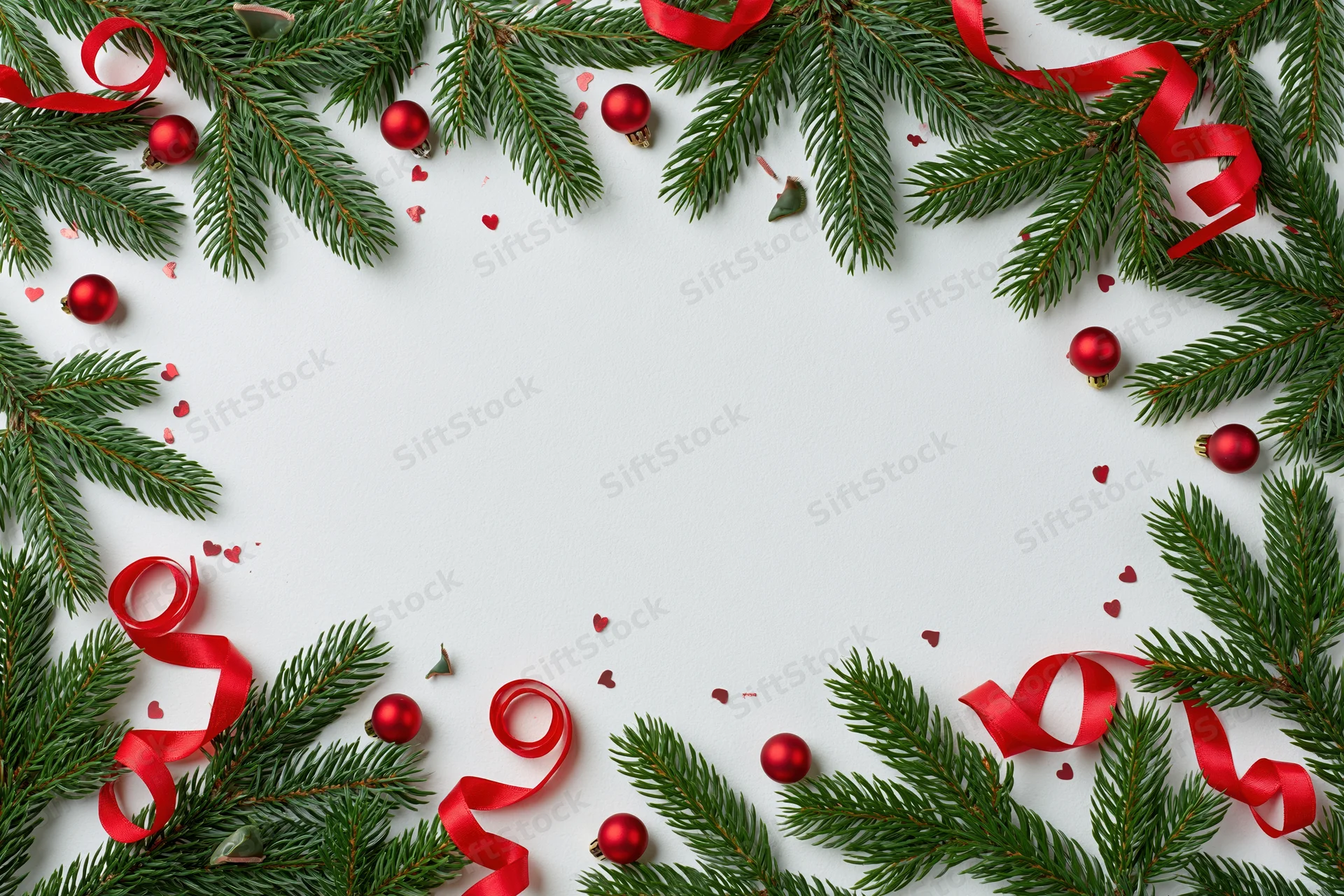 Christmas border frame made of fir branches and red ribbons on white background with copyspace
