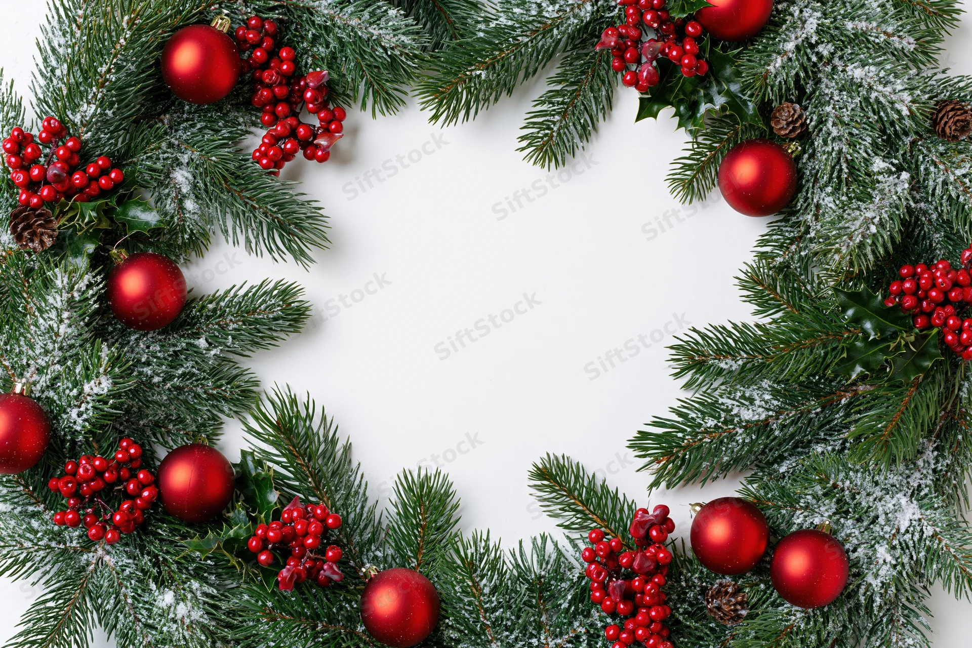 Christmas wreath border made of pine and fir branches with red ornaments and berries on white background