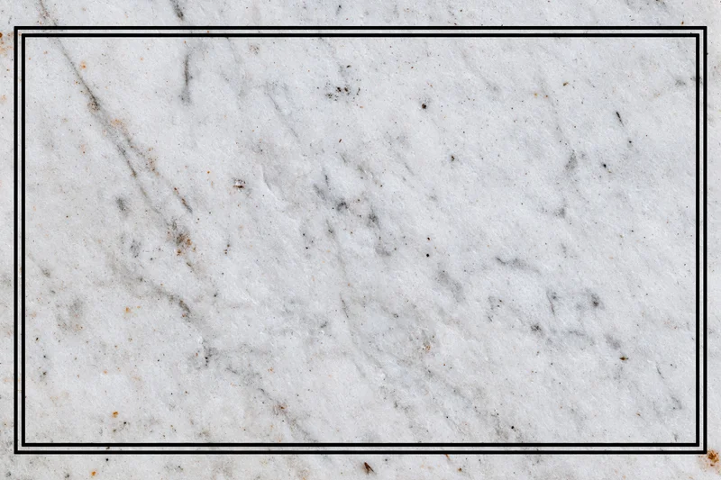 Close-up of aged white marble surface with grey veining and speckles