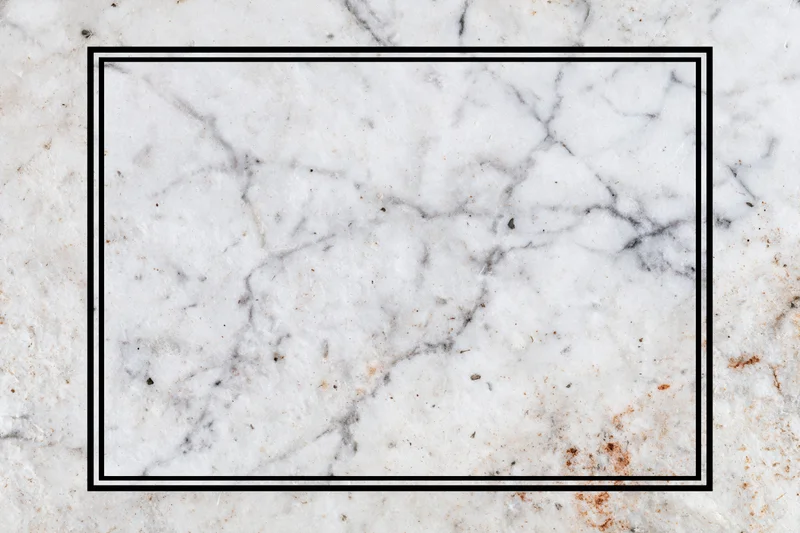 Aged white marble surface with grey veining and black rectangular frame