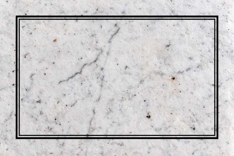 Aged white marble surface with grey veining and speckles in flat lay closeup