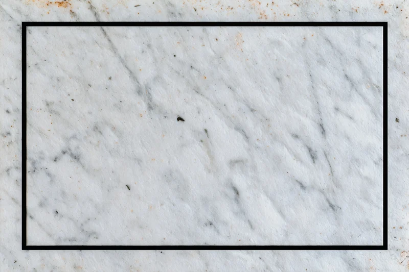 Aged white marble surface with grey veining and black border frame