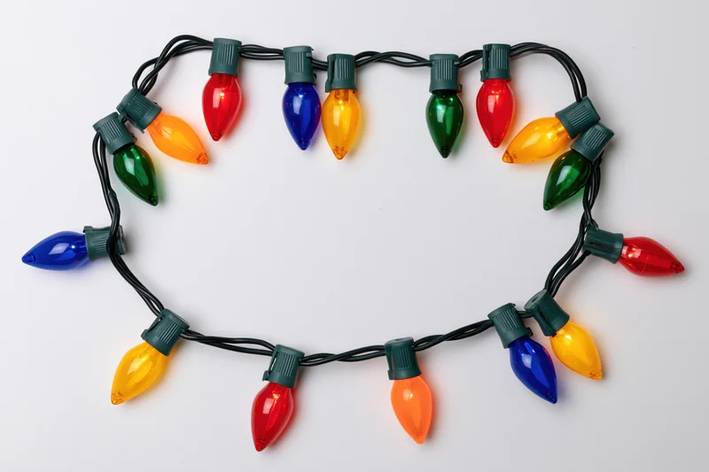 Multicolored christmas string lights arranged in a rectangular frame on white background