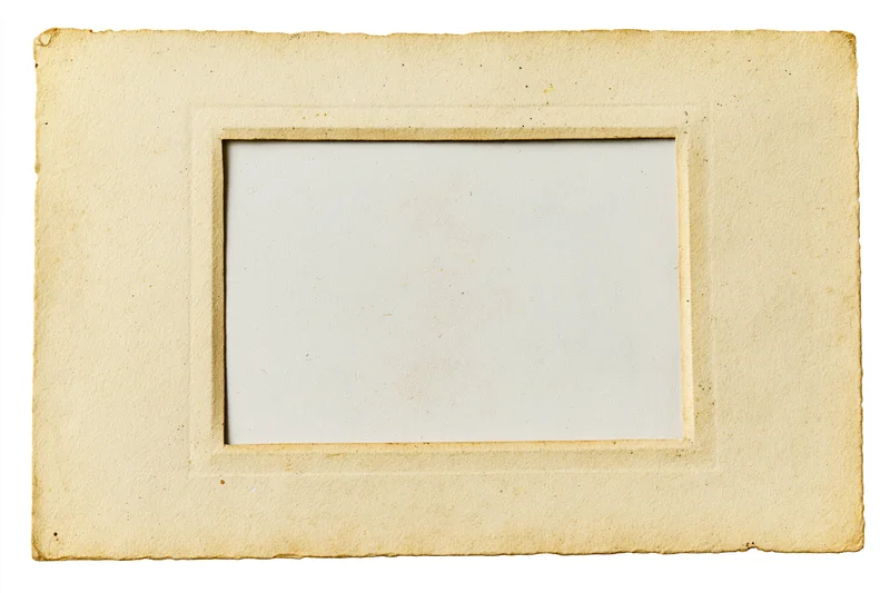 Vintage paper photo frame border with white center on plain background