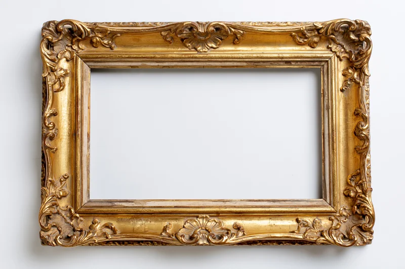Ornate antique gold picture frame with baroque carved floral details on white background