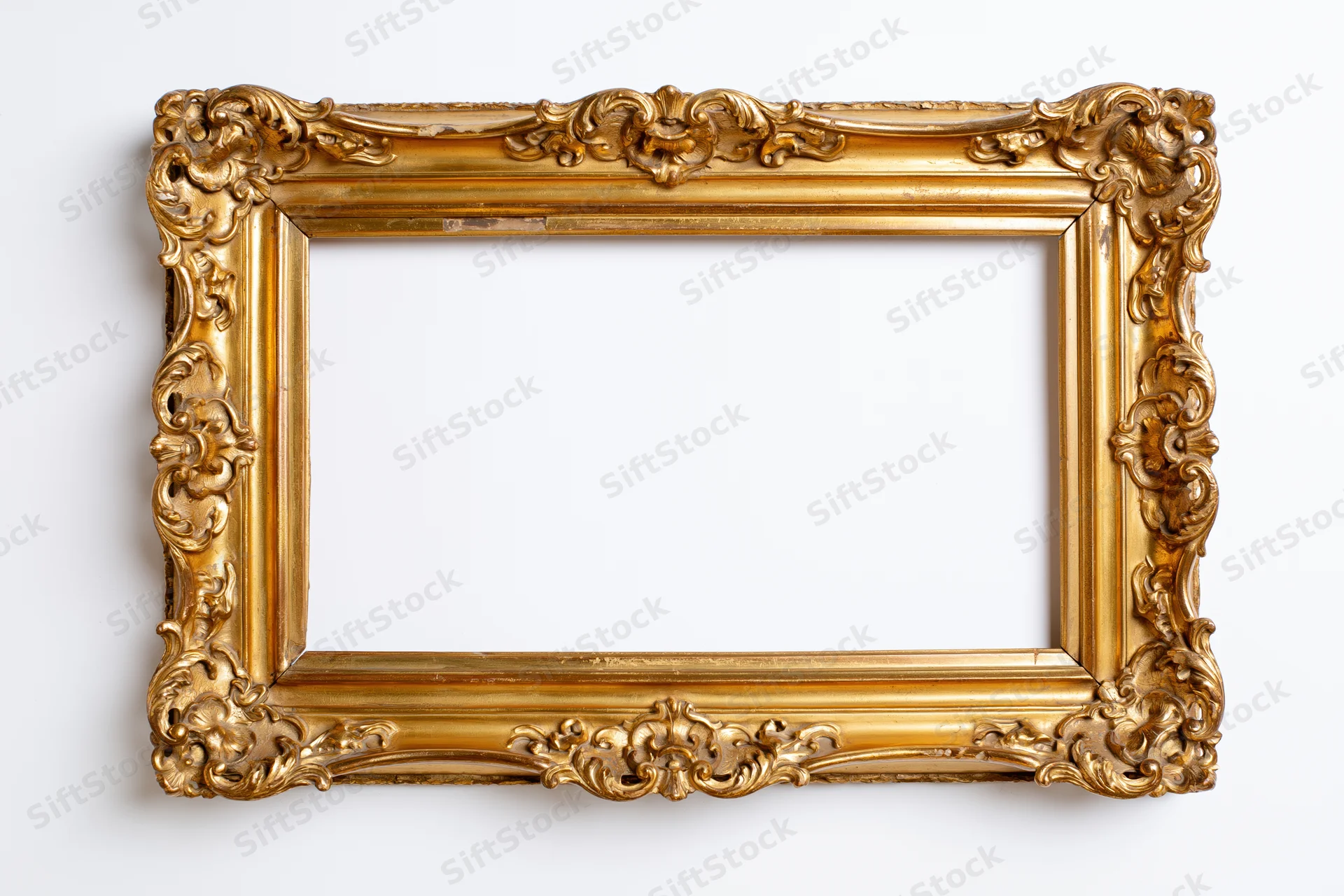 Ornate antique gold picture frame with baroque carved floral details on white background