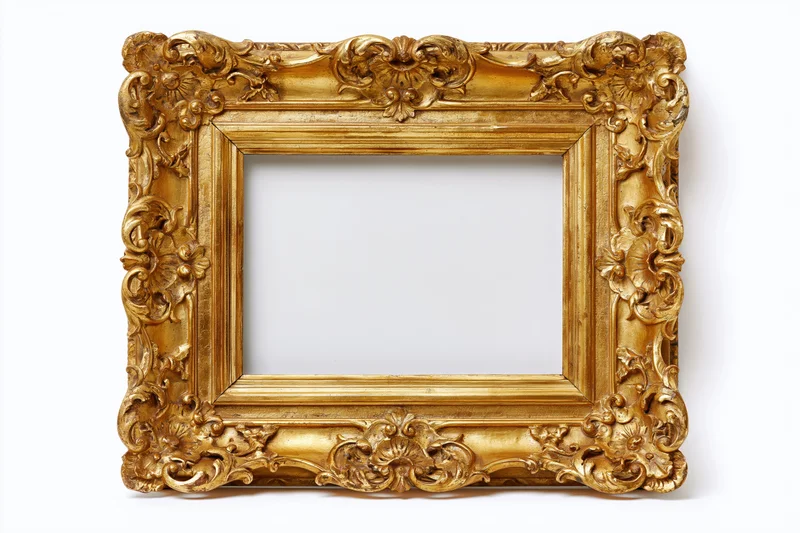 Ornate gold baroque frame with carved floral details isolated on white