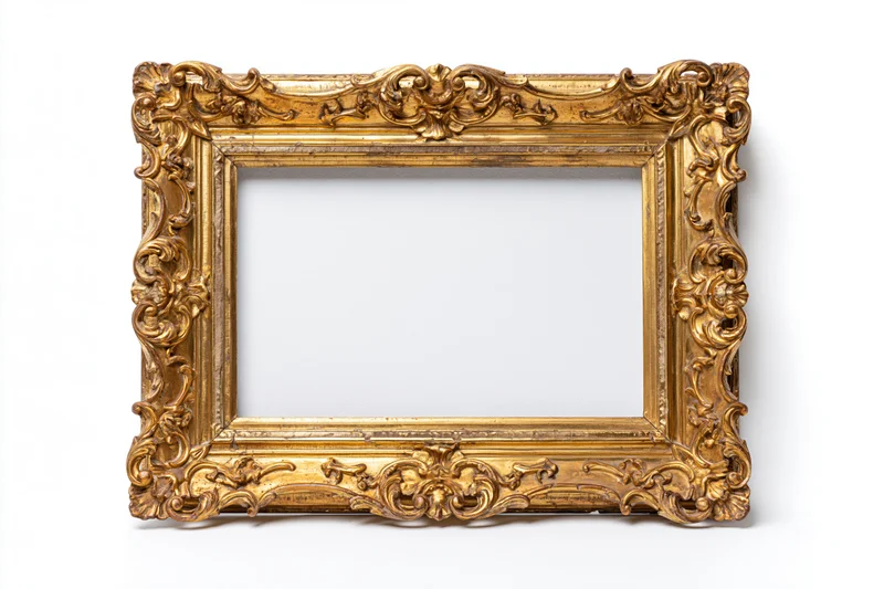 Ornate antique gold picture frame with baroque carved scrollwork isolated on white background