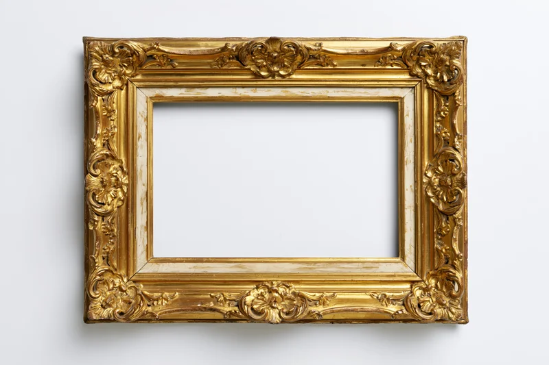 Ornate antique gold picture frame with baroque floral relief on white background