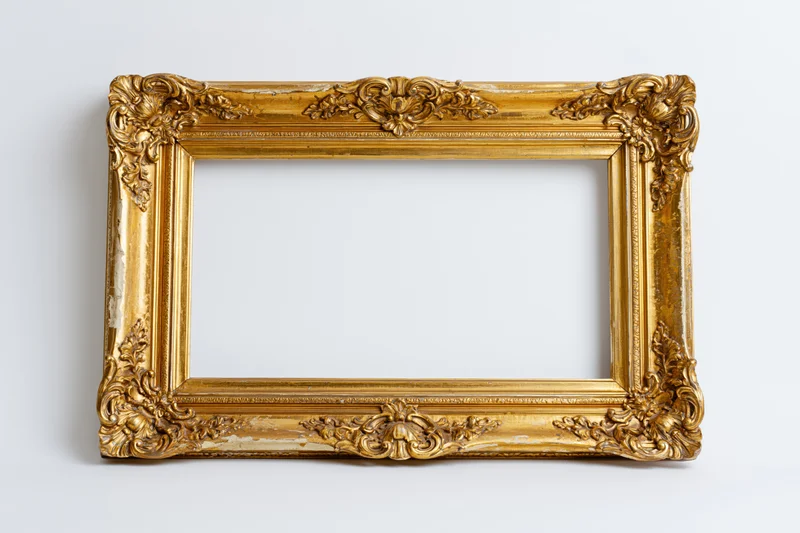 Ornate antique gold picture frame with baroque floral relief on white background