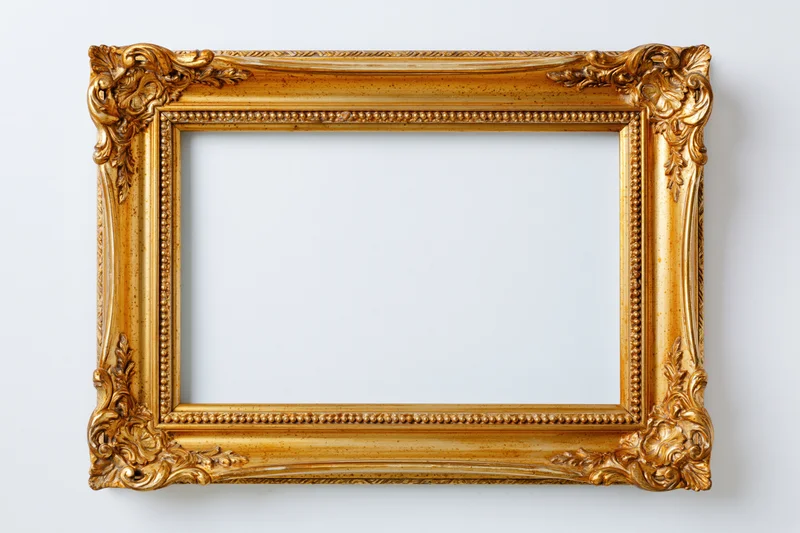 Ornate gold antique frame with empty white interior against plain background