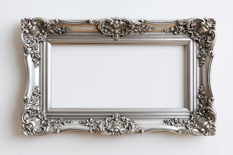 Ornate silver picture frame with baroque floral detailing on white background