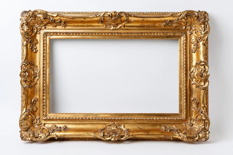 Ornate baroque-style gold frame with empty white interior against plain background