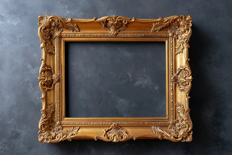 Ornate gold baroque frame with empty dark interior on textured gray surface