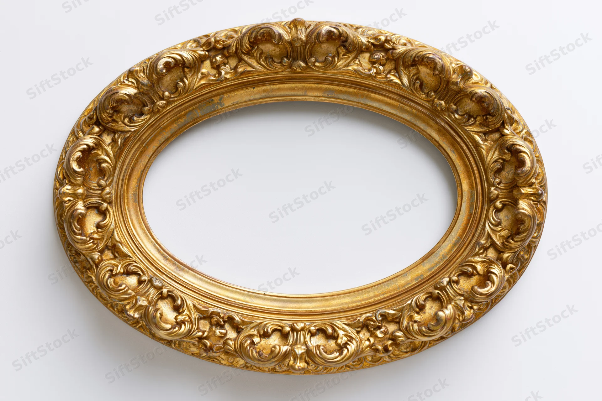 Ornate oval gilt frame with baroque scrollwork on white background