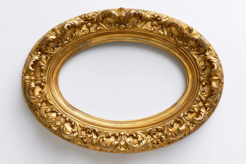 Ornate oval gilt frame with baroque scrollwork on white background