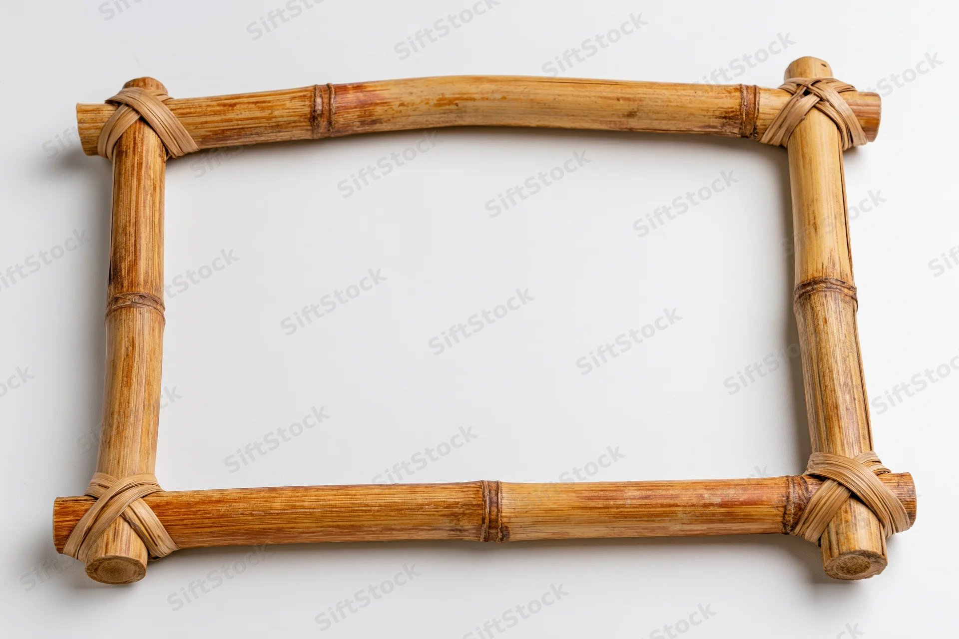 Rectangular bamboo frame made of natural poles with woven joints on white background