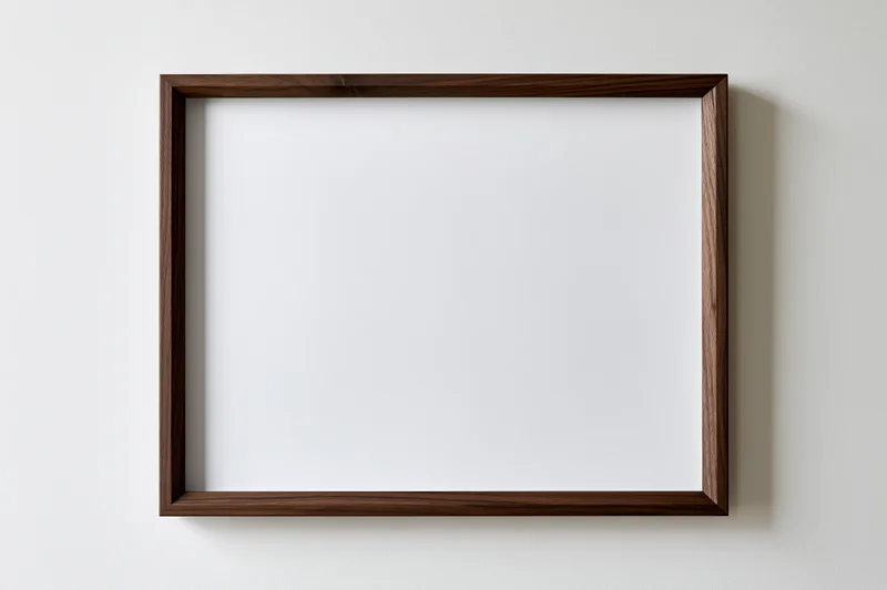 Dark walnut wood picture frame with blank white interior hanging on a white wall