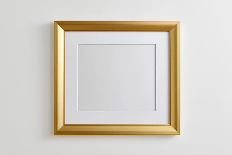 Gold picture frame with white mat hanging on a plain wall