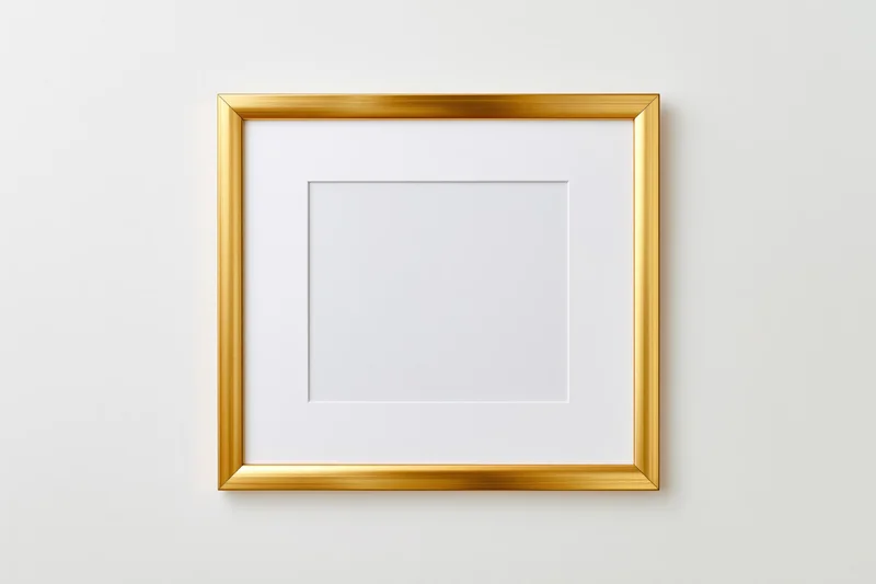 Gold metal picture frame with white mat insert hanging on a plain wall