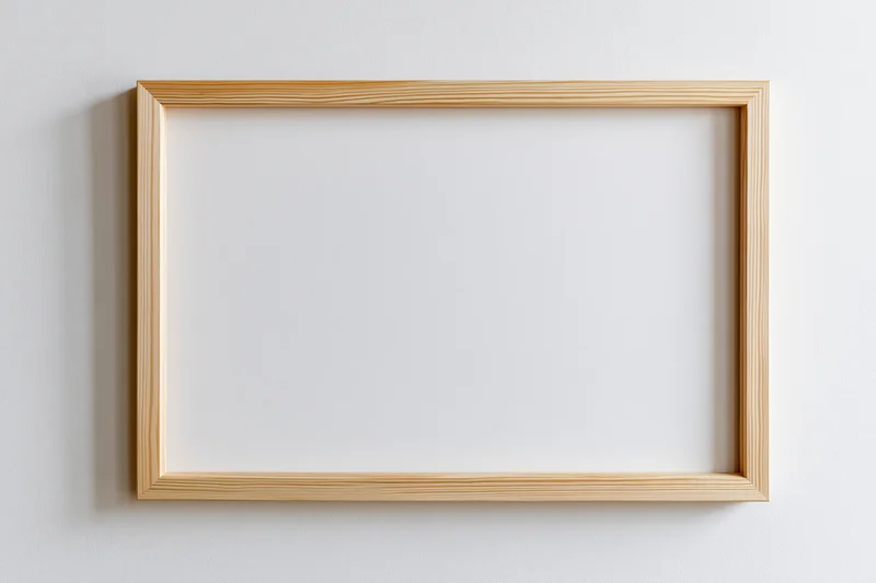 Light wooden rectangular frame hanging on a white wall with blank interior